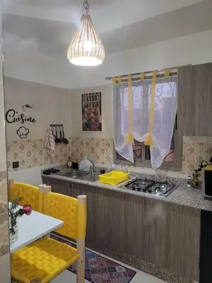 a kitchen with a sink and a stove top oven at Le cœur de L'orient Marrakech in Marrakech