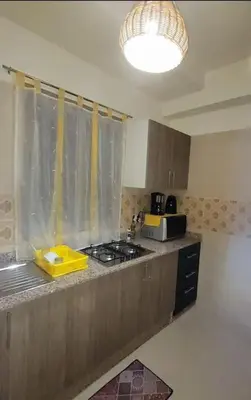 a kitchen with a sink and a stove top oven at Le cœur de L'orient Marrakech in Marrakech