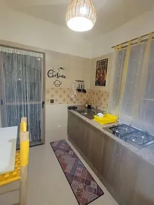 a kitchen with a counter with a sink and a window at Le cœur de L'orient Marrakech in Marrakech