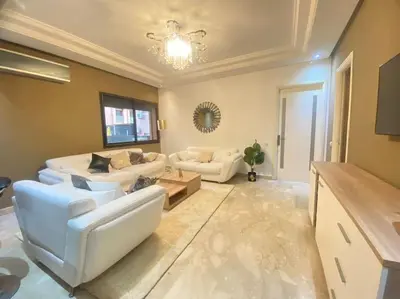 a large living room with white furniture and a chandelier at new and modern apartment in Marrakech