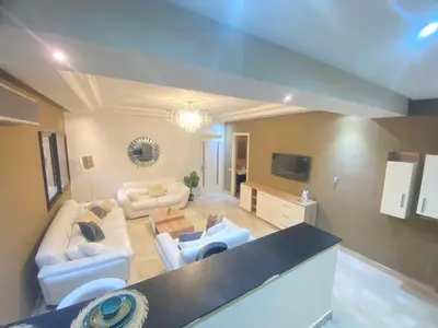 a living room with a couch and a table at new and modern apartment in Marrakech