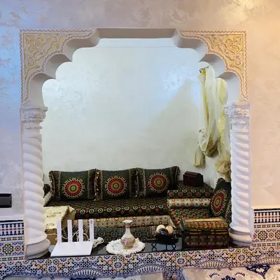 a living room with a couch in a wall at Dar Al-Karma in Marrakech