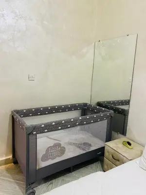 a small bed in a room with a mirror at Dar Al-Karma in Marrakech