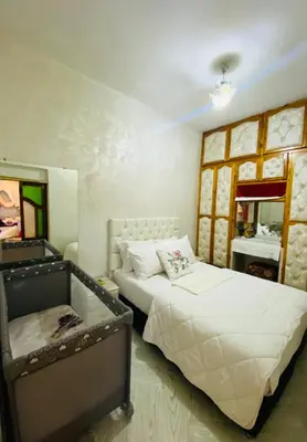 a bedroom with two beds and a mirror at Dar Al-Karma in Marrakech