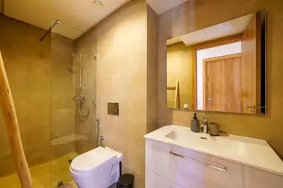 a bathroom with a toilet and a sink and a shower at Appartement NOVA Noria in Marrakech