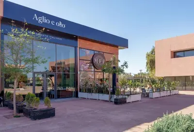 a store front with potted plants outside of it at Appartement NOVA Noria in Marrakech