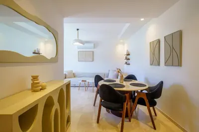 a dining room with a table and chairs at Appartement NOVA Noria in Marrakech