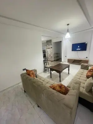 a living room with a couch and a table at Luxury Apartment in Marrakesh two in Marrakech
