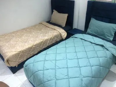 a bedroom with a blue bed and a pillow at Luxury Apartment in Marrakesh two in Marrakech