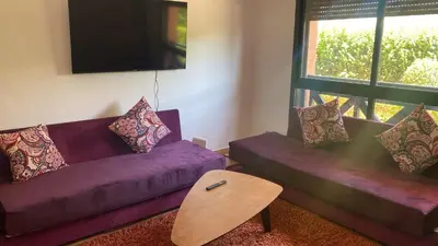 a living room with two purple couches and a table at M32 Cosy Loft in Marrakech