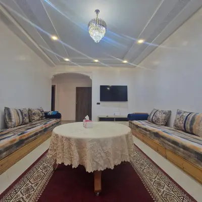a living room with couches and a table and a tv at New DUPLEX jardins d'anas- Avenue guemassa Near Airport in Marrakech
