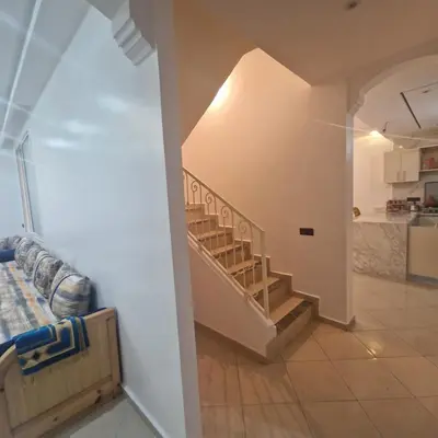 a hallway with a spiral staircase in a house at New DUPLEX jardins d'anas- Avenue guemassa Near Airport in Marrakech