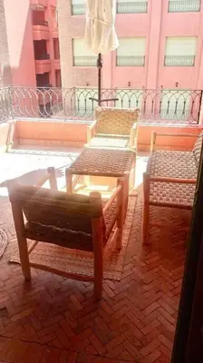 two chairs and a table on a balcony at Beautiful Hivernage Apartment with Pool & Balcony, Near Attractions in Marrakech