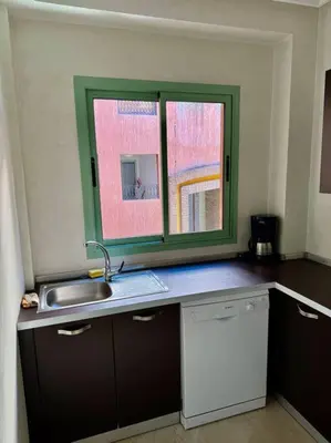 a kitchen with a sink and a window at Beautiful Hivernage Apartment with Pool & Balcony, Near Attractions in Marrakech