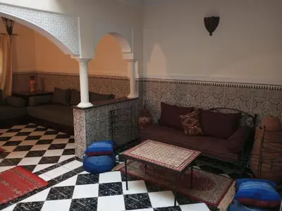 a living room with a couch and a checkered floor at Riad Selma résidence face Médina avec Piscines in Marrakech