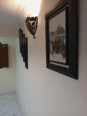 a picture of a horse on a wall with a light at Riad Selma résidence face Médina avec Piscines in Marrakech