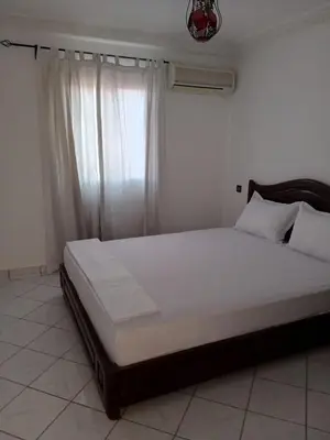 a large bed in a room with a window at Riad Selma résidence face Médina avec Piscines in Marrakech