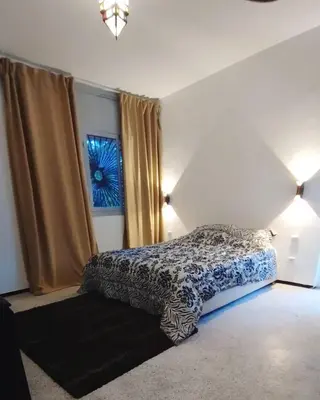 a bedroom with a bed and a window at Splendide villa de charme à Marrakech in Marrakech