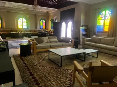 a living room with couches and a coffee table at Splendide villa de charme à Marrakech in Marrakech