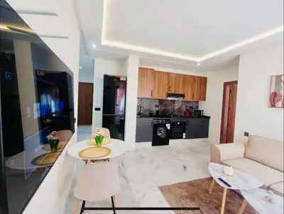 a living room with a couch and a table at Charmant appartement en plein centre ville gueliz in Marrakech