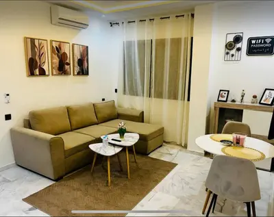 a living room with a couch and a table at Charmant appartement en plein centre ville gueliz in Marrakech