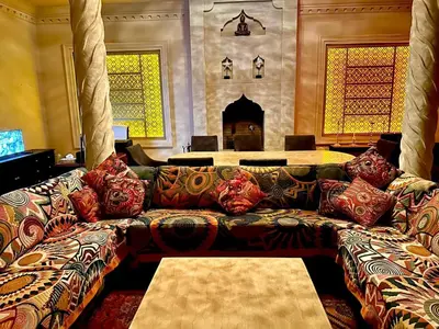 a living room with a couch with pillows at Villa Shambhala in Marrakech