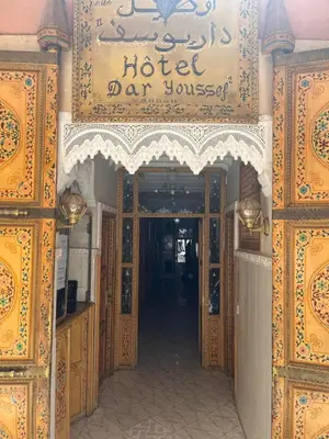 an entrance to a hotel carosset with a sign at DarYOUSSEF 68 in Marrakech