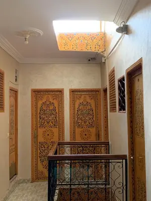 a hallway with wooden doors and a ceiling with a skylight at DarYOUSSEF 68 in Marrakech