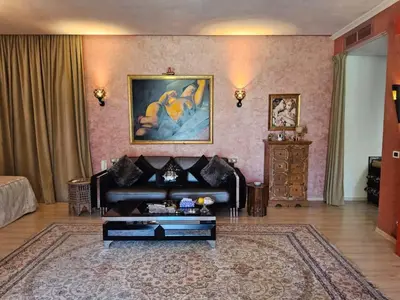 a living room with a couch and a table at Palais Oussoud in Sidi Yahia az Zaʼer