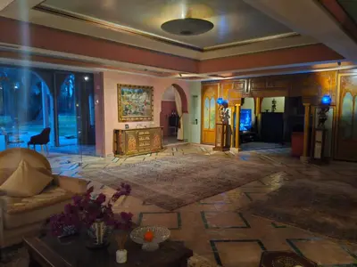 a living room with a couch and a table at Palais Oussoud in Sidi Yahia az Zaʼer