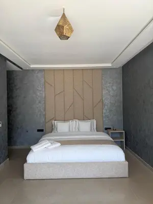 a bedroom with a large white bed in a room at AD Villa in Marrakech