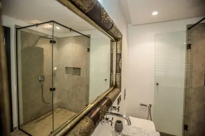 a bathroom with a shower and a sink and a mirror at AD Villa in Marrakech
