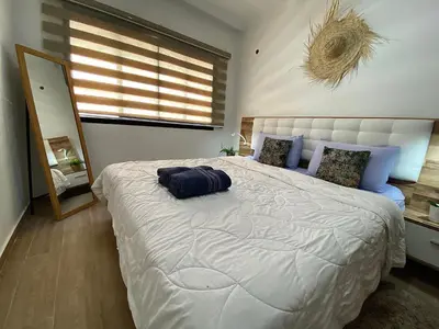 a bedroom with a large bed with a pillow on it at apparte 2 chambres luxe en face la gare gueliz in Marrakech