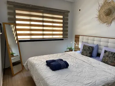 a bedroom with a bed with a pillow on it at apparte 2 chambres luxe en face la gare gueliz in Marrakech