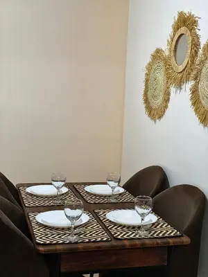a table with wine glasses on top of it at apparte 2 chambres luxe en face la gare gueliz in Marrakech