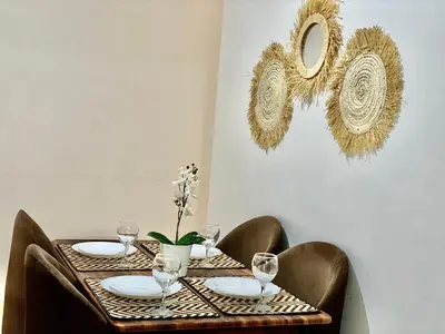 a table with plates and wine glasses on it at apparte 2 chambres luxe en face la gare gueliz in Marrakech
