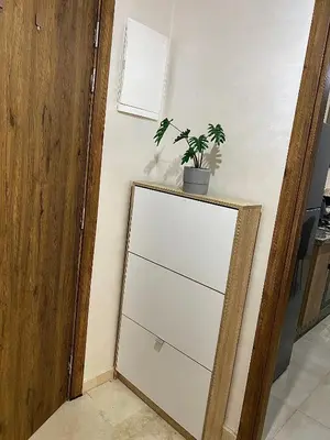 a white dresser with a plant on top of it at apparte 2 chambres luxe en face la gare gueliz in Marrakech