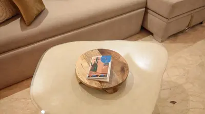 a table with a book on top of a stool at Piscine chauffée - Sauna - Hammam - Appart Coeur de Gueliz in Marrakech