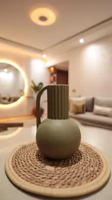 a vase sitting on a table in a living room at Piscine chauffée - Sauna - Hammam - Appart Coeur de Gueliz in Marrakech
