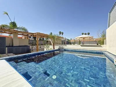 a swimming pool in the middle of a house at Riad Azrak in Marrakech