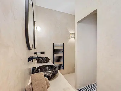 a bathroom with a black sink and a mirror at Riad Azrak in Marrakech
