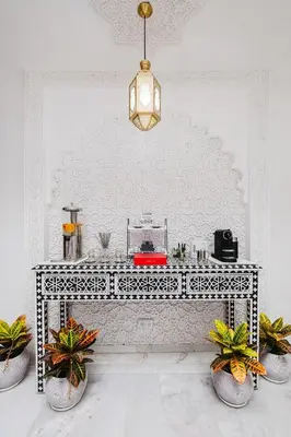 a white room with a table with potted plants at Free People Riad and Spa in Marrakech