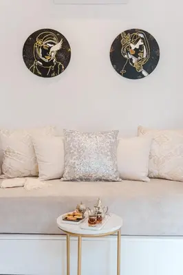 a couch with a table with a plate of food on it at Free People Riad and Spa in Marrakech