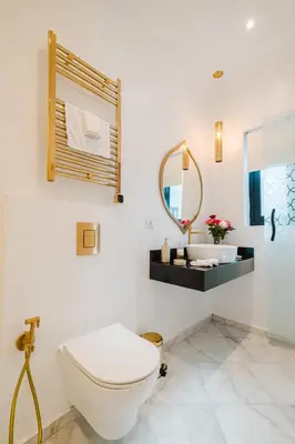 a white bathroom with a toilet and a sink at Free People Riad and Spa in Marrakech