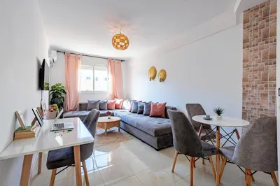 a living room with a couch and a table at Appartement familial à Marrakech in Marrakech