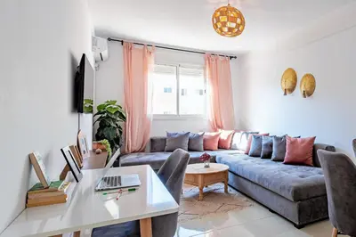 a living room with a couch and a table at Appartement familial à Marrakech in Marrakech