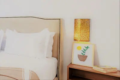a bedroom with a bed and a lamp on a night stand at Appartement familial à Marrakech in Marrakech