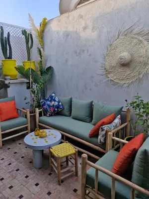 a patio with a couch and chairs and a table at Luxueux Duplex rooftop en plein cœur de Majorelle in Marrakech