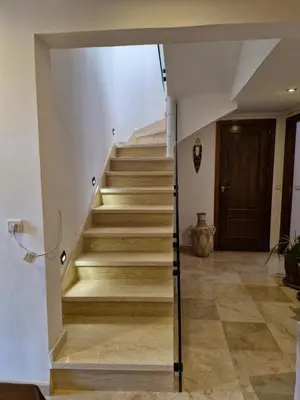 a staircase in a house with wooden floors at Luxueux Duplex rooftop en plein cœur de Majorelle in Marrakech
