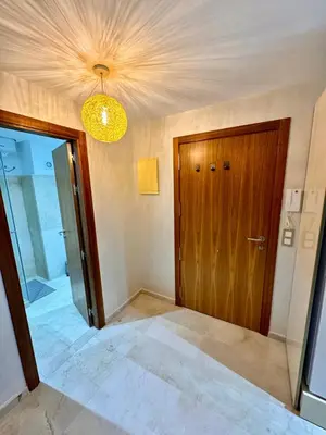 a room with a wooden door and a chandelier at Pearl Garden Studio Luxueux Piscine Sunny Terrasse in Marrakech